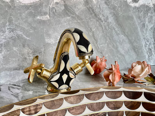 Handmade Brass Faucet – Wall Mount solid unlacquered brass tap with black and white geometric inlay design, displayed on a marble surface with pink roses.