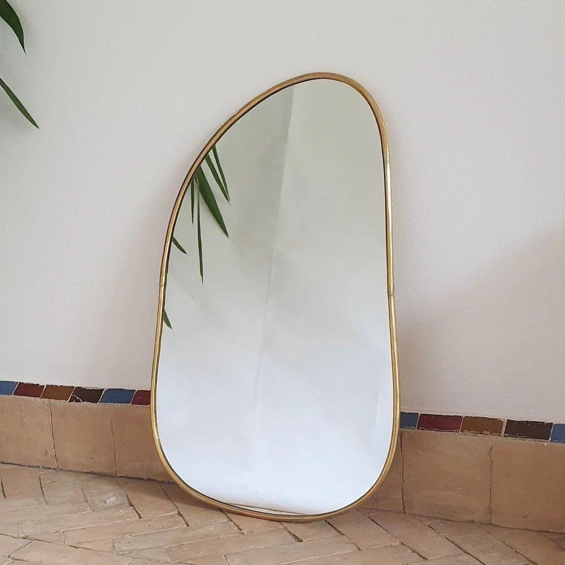 Asymmetrical Brass Framed Wall Mirror with a modern brass finish, featuring an irregular shape for contemporary home decor.