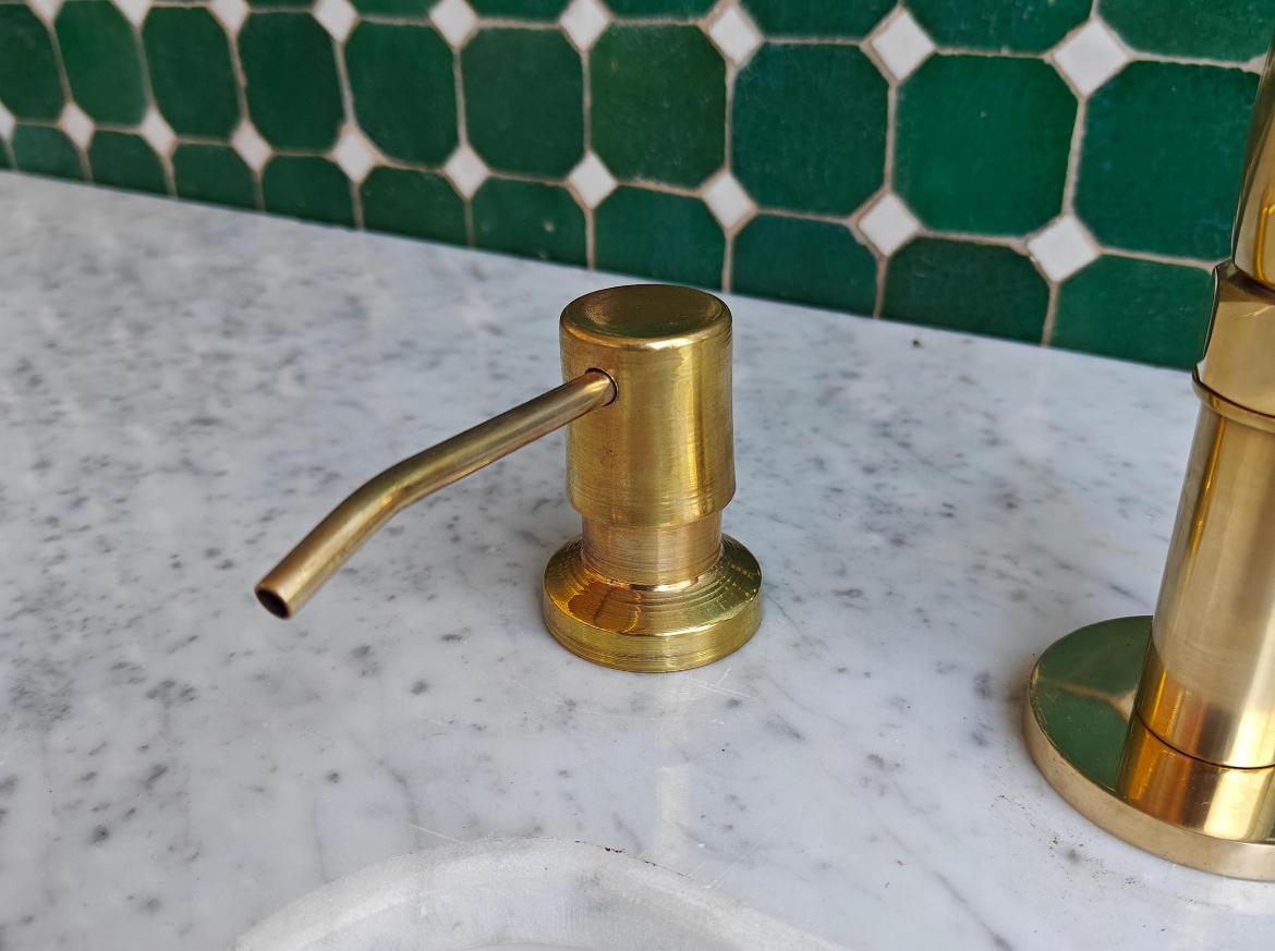 Bridge kitchen faucet with side sprayer in unlacquered brass, showcasing a durable brass finish and modern design for kitchen use.